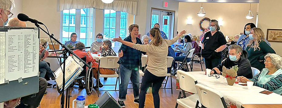 Seniors dancing and listening to music at Holiday Party.