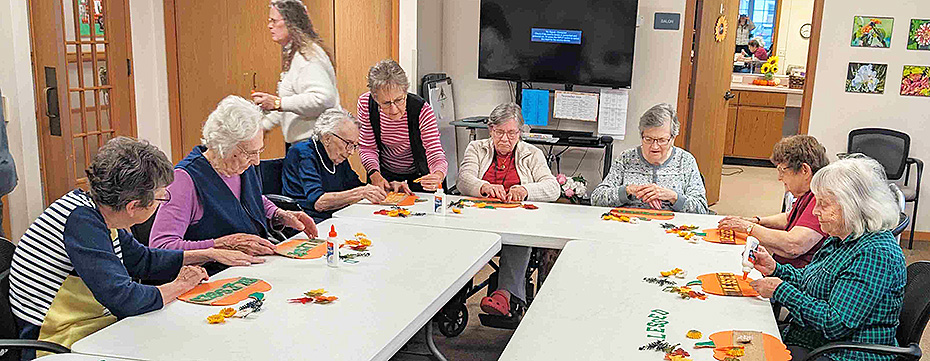 Ladies work on a Thanksgiving craft together