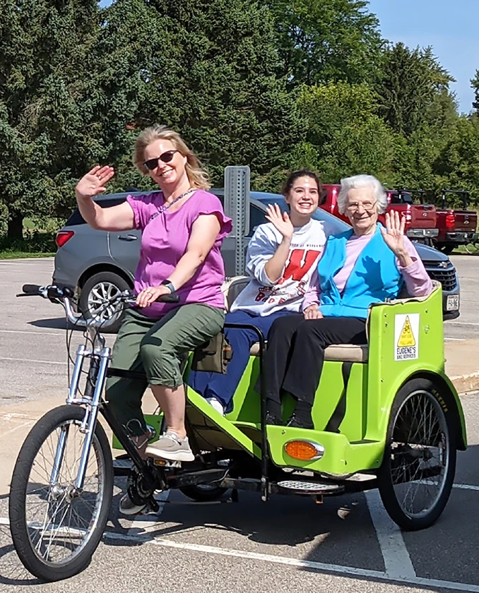 Meadows residents riding in pedal trike