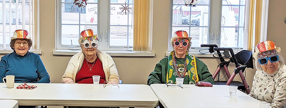 Meadows folks celebrates February birthdays with funny hats and glasses